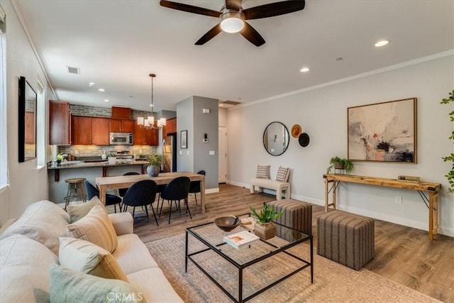 3591 Sacramento Dr Unit 208, San Luis Obispo, CA 93401 - living area with light wood-type flooring, a ceiling fan, recessed lighting, a chandelier, and crown molding