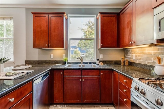 3591 Sacramento Dr Unit 208, San Luis Obispo, CA 93401 - kitchen featuring white appliances, reddish brown cabinets, tasteful backsplash, crown molding, and dark stone counters