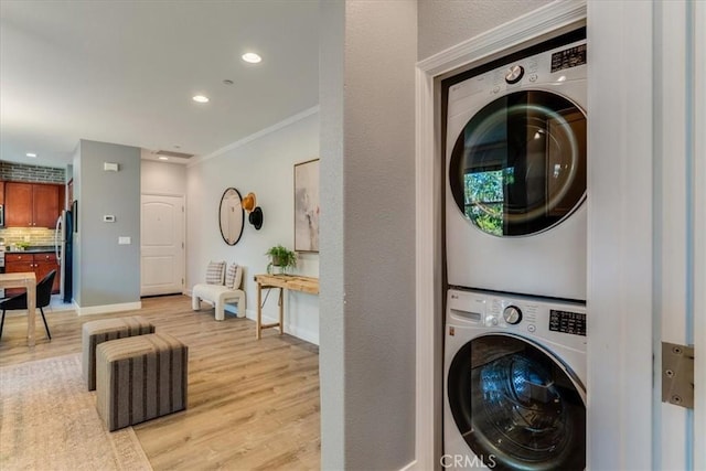 3591 Sacramento Dr Unit 208, San Luis Obispo, CA 93401 - laundry area featuring stacked washer / drying machine, light wood finished floors, crown molding, and recessed lighting