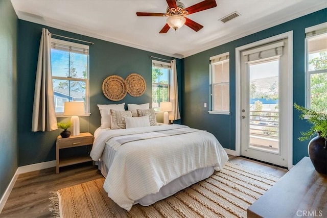 3591 Sacramento Dr Unit 208, San Luis Obispo, CA 93401 - bedroom featuring access to exterior, multiple windows, crown molding, wood finished floors, and a ceiling fan