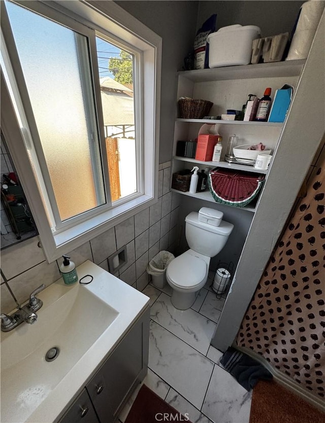 8648 Chestnut Ave, South Gate, CA 90280 - full bath with vanity, tile walls, marble finish floors, and a shower