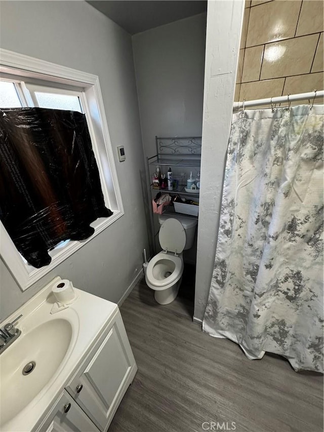 8648 Chestnut Ave, South Gate, CA 90280 - bathroom with wood finished floors, vanity, and a shower with curtain