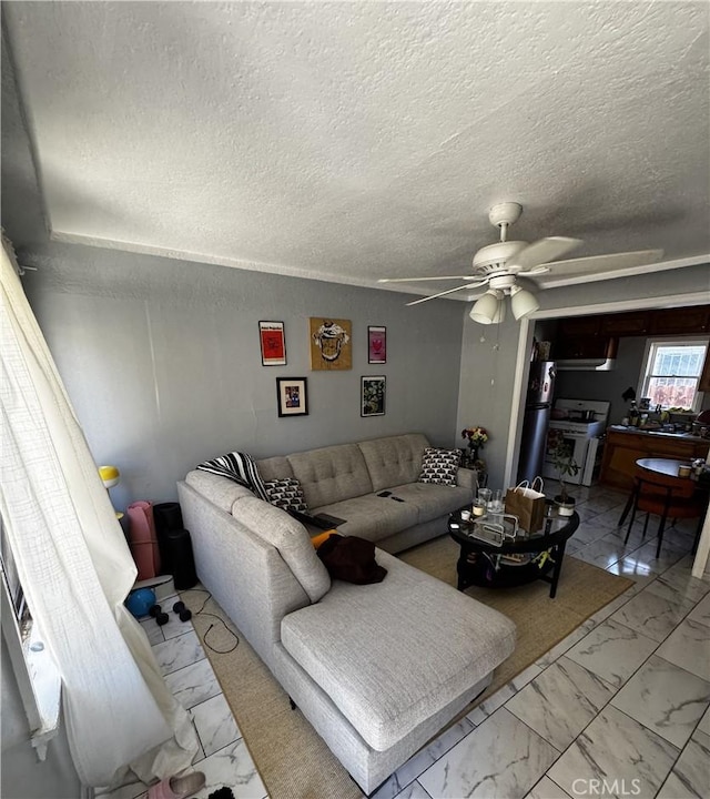 8648 Chestnut Ave, South Gate, CA 90280 - living area featuring marble finish floors, ceiling fan, and a textured ceiling