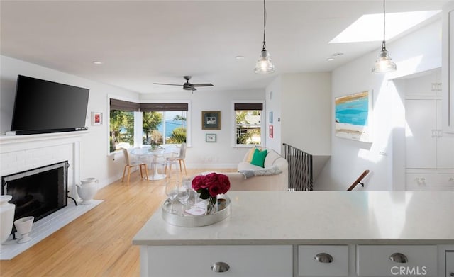 31907 9th Ave, Laguna Beach, CA 92651 - living room featuring light wood-style flooring, a skylight, a brick fireplace, ceiling fan, and recessed lighting