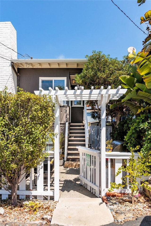 31907 9th Ave, Laguna Beach, CA 92651 - view of front of house featuring stucco siding, stairway, a chimney, and a gate