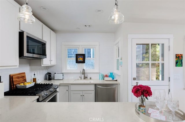 31907 9th Ave, Laguna Beach, CA 92651 - kitchen with appliances with stainless steel finishes, light countertops, tasteful backsplash, and white cabinetry