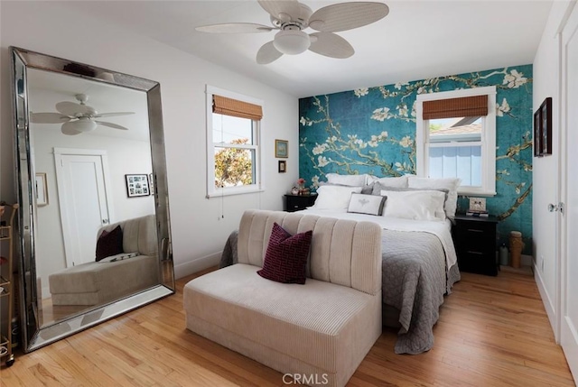 31907 9th Ave, Laguna Beach, CA 92651 - bedroom featuring wallpapered walls, multiple windows, light wood-style floors, and ceiling fan