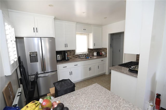 2432 N Eastern Ave, Los Angeles, CA 90032 - kitchen featuring stainless steel refrigerator with ice dispenser, tasteful backsplash, and white cabinets