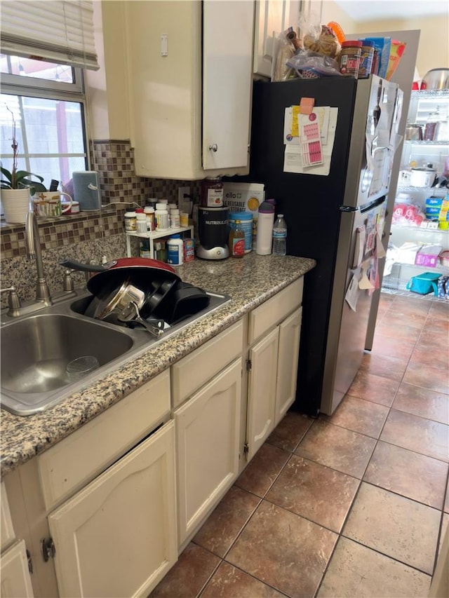 2432 N Eastern Ave, Los Angeles, CA 90032 - kitchen featuring backsplash, light countertops, tile patterned flooring, white cabinetry, and freestanding refrigerator