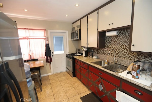 2432 N Eastern Ave, Los Angeles, CA 90032 - kitchen featuring stainless steel appliances, backsplash, light tile patterned floors, light countertops, and recessed lighting