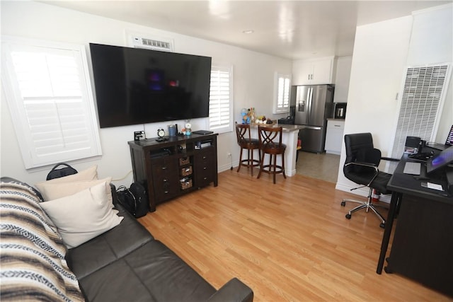 2432 N Eastern Ave, Los Angeles, CA 90032 - living room with a heating unit, light wood-type flooring, and an office area