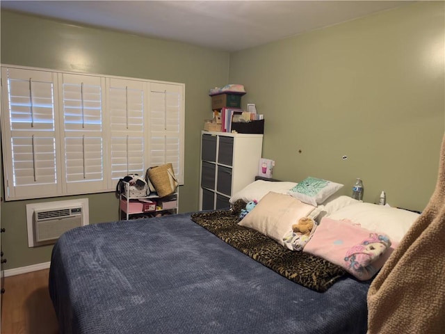 2432 N Eastern Ave, Los Angeles, CA 90032 - bedroom featuring a wall mounted air conditioner and wood finished floors