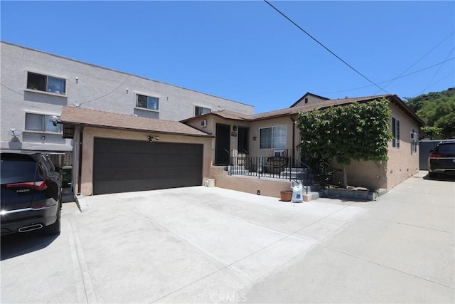 2432 N Eastern Ave, Los Angeles, CA 90032 - view of front of property featuring stucco siding, driveway, and a garage