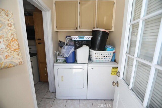 2432 N Eastern Ave, Los Angeles, CA 90032 - laundry room featuring cabinet space, separate washer and dryer, and light tile patterned floors