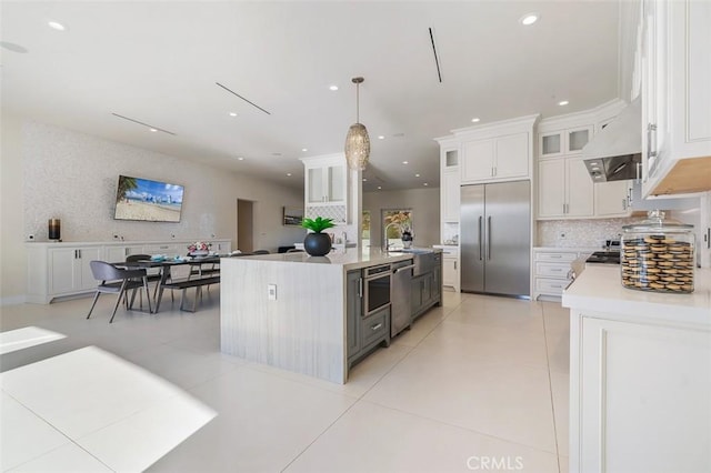 109 Buckskin Rd, Bell Canyon, CA 91307 - kitchen with appliances with stainless steel finishes, under cabinet range hood, light countertops, light tile patterned flooring, and recessed lighting