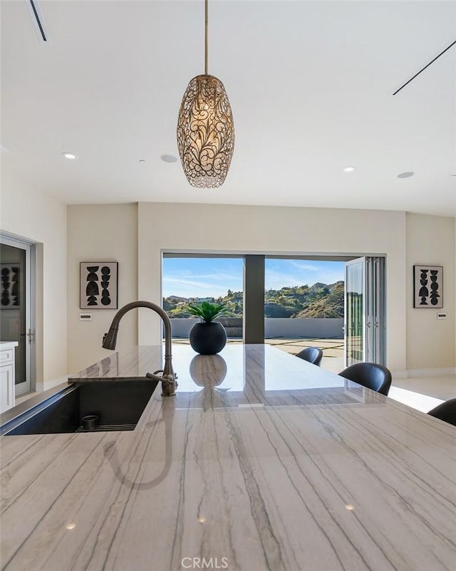 109 Buckskin Rd, Bell Canyon, CA 91307 - kitchen featuring light stone countertops, hanging light fixtures, recessed lighting, and white cabinets