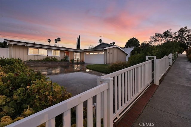 20516 Aetna St, Woodland Hills, CA 91367 - view of front of house with asphalt driveway, a garage, and board and batten siding