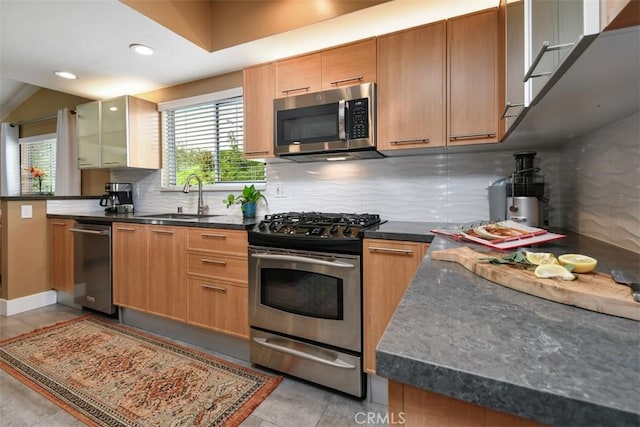20516 Aetna St, Woodland Hills, CA 91367 - kitchen featuring stainless steel appliances, tasteful backsplash, recessed lighting, light tile patterned floors, and glass insert cabinets