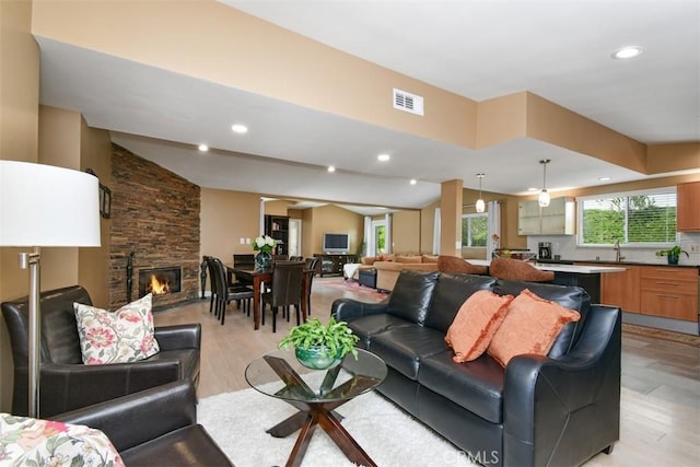20516 Aetna St, Woodland Hills, CA 91367 - living area with a stone fireplace, light wood-style floors, and recessed lighting
