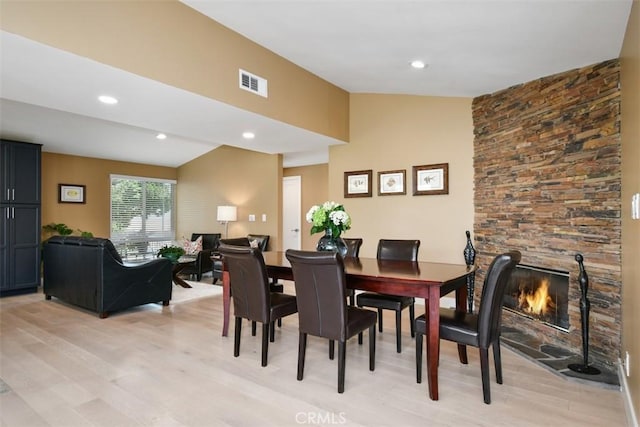 20516 Aetna St, Woodland Hills, CA 91367 - dining space with light wood finished floors, lofted ceiling, recessed lighting, and a fireplace
