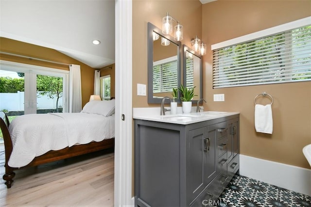 20516 Aetna St, Woodland Hills, CA 91367 - bathroom with french doors, double vanity, ensuite bathroom, wood finished floors, and recessed lighting