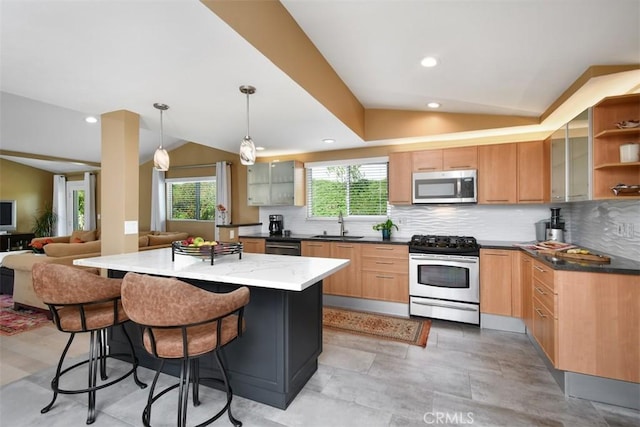 20516 Aetna St, Woodland Hills, CA 91367 - kitchen with stainless steel appliances, vaulted ceiling, plenty of natural light, tasteful backsplash, and a kitchen breakfast bar