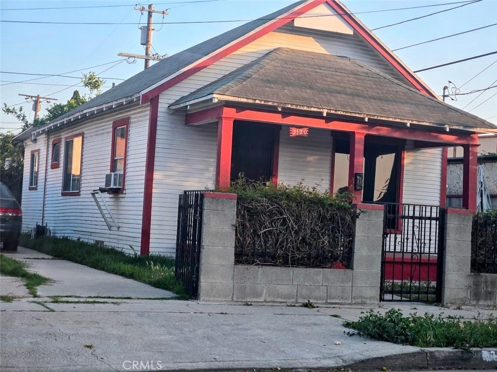 3120 W 63rd St, Los Angeles, CA 90043 - bungalow with covered porch, a fenced front yard, and cooling unit