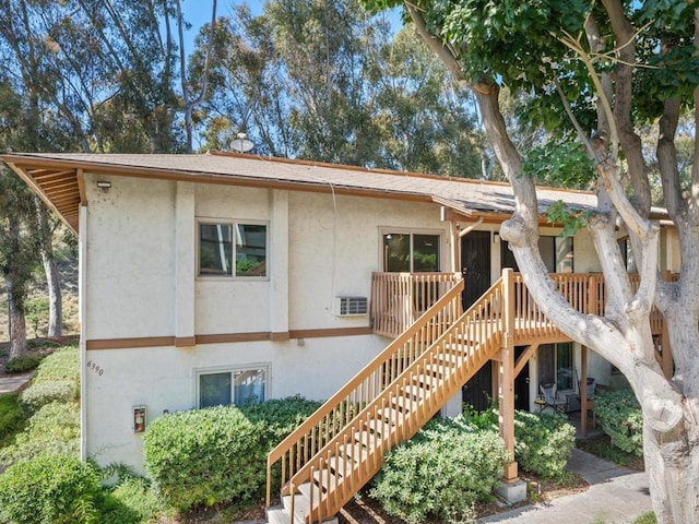 6390 Rancho Mission Rd Unit 202, San Diego, CA 92108 - view of front of property featuring stucco siding, stairway, and a wooden deck