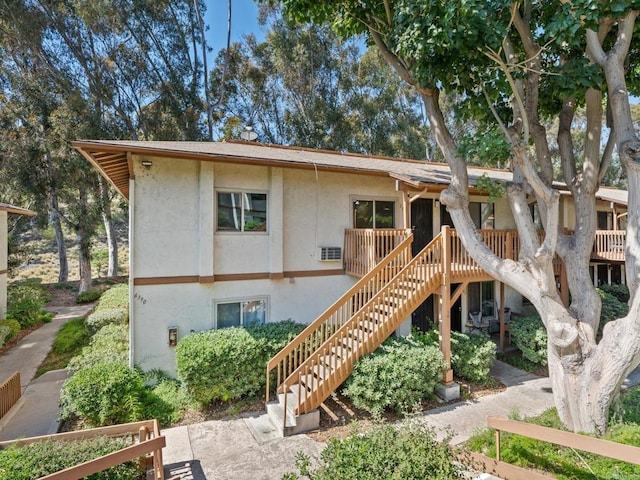 6390 Rancho Mission Rd Unit 202, San Diego, CA 92108 - rear view of property with stairs, stucco siding, and a deck