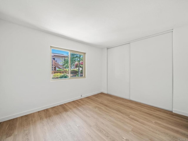 6390 Rancho Mission Rd Unit 202, San Diego, CA 92108 - unfurnished bedroom featuring light wood-style floors and a closet