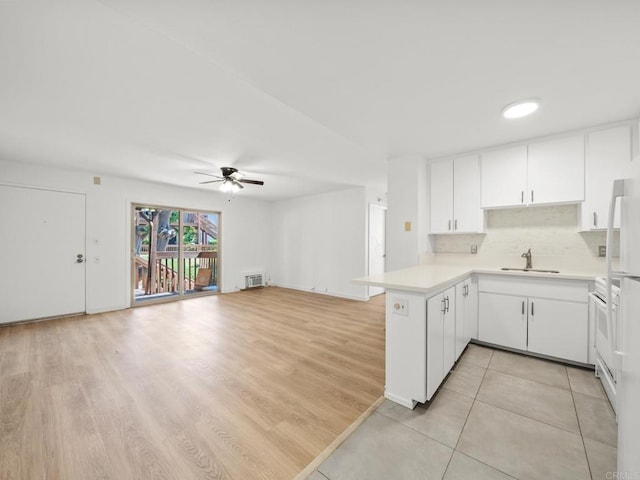 6390 Rancho Mission Rd Unit 202, San Diego, CA 92108 - kitchen with a peninsula, light countertops, ceiling fan, white cabinetry, and open floor plan