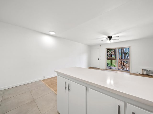 6390 Rancho Mission Rd Unit 202, San Diego, CA 92108 - kitchen featuring white cabinetry, a ceiling fan, light countertops, and light tile patterned floors