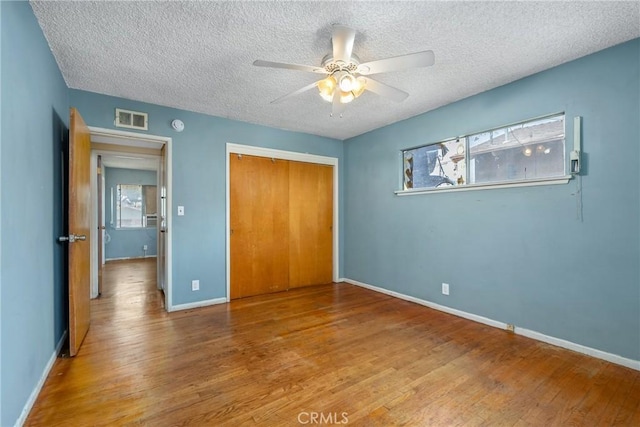 502 Tasman Ave, Pomona, CA 91767 - unfurnished bedroom featuring a textured ceiling, wood finished floors, a closet, and ceiling fan