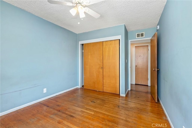 502 Tasman Ave, Pomona, CA 91767 - unfurnished bedroom featuring a closet, wood finished floors, a textured ceiling, and ceiling fan