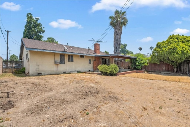 502 Tasman Ave, Pomona, CA 91767 - back of property with a fenced backyard, a chimney, stucco siding, and cooling unit
