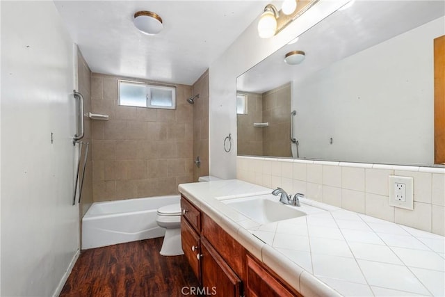 502 Tasman Ave, Pomona, CA 91767 - bathroom featuring vanity, wood finished floors, shower / washtub combination, and decorative backsplash