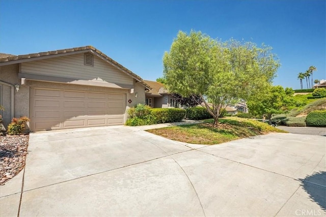 81 Via Larga Vis, Bonsall, CA 92003 - view of front of home with concrete driveway, a garage, stucco siding, and a tile roof