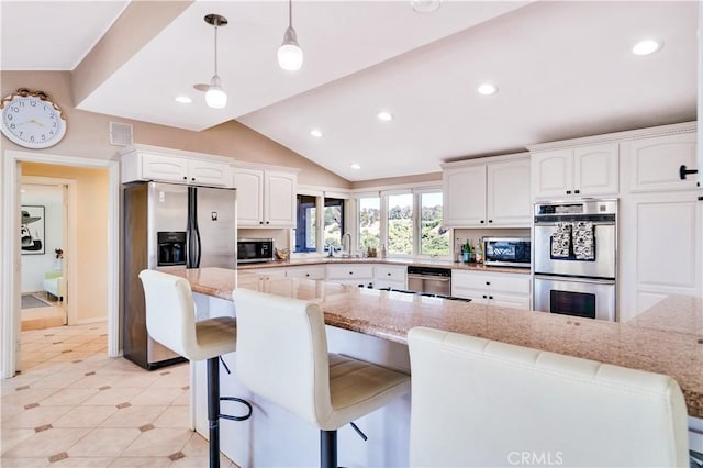 13 Buggy Whip Dr, Rolling Hills, CA 90274 - kitchen featuring stainless steel appliances, white cabinets, light stone countertops, a kitchen breakfast bar, and lofted ceiling
