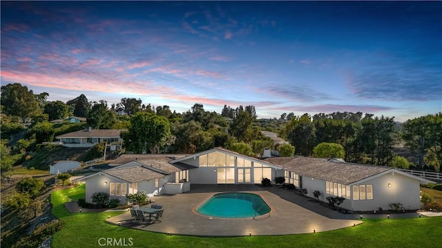 13 Buggy Whip Dr, Rolling Hills, CA 90274 - pool at dusk with a patio, a yard, an outdoor pool, and view of wooded area