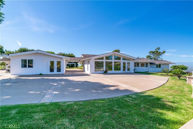 13 Buggy Whip Dr, Rolling Hills, CA 90274 - rear view of property featuring french doors, a lawn, stucco siding, and a patio