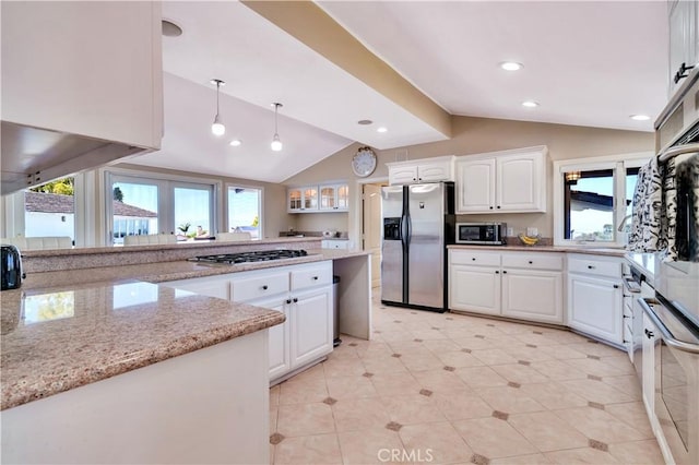 13 Buggy Whip Dr, Rolling Hills, CA 90274 - kitchen featuring appliances with stainless steel finishes, lofted ceiling, white cabinetry, glass insert cabinets, and light stone counters