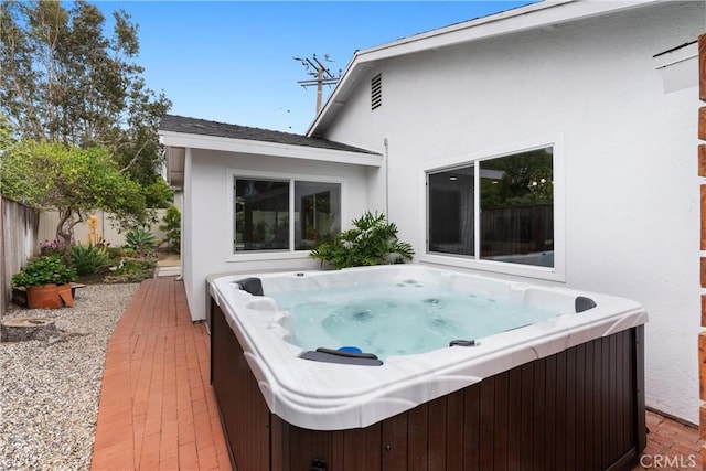 2008 N Capella Ct, Costa Mesa, CA 92626 - back of house featuring a hot tub and stucco siding