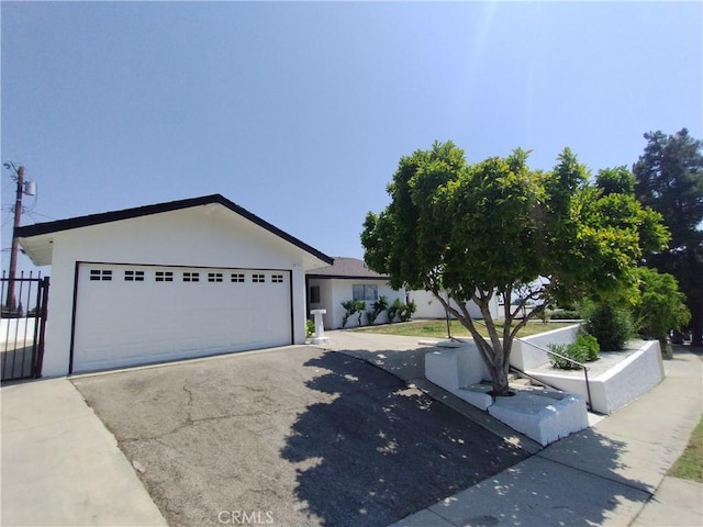 13410 Berg St, Sylmar, CA 91342 - ranch-style home featuring a garage, stucco siding, and asphalt driveway
