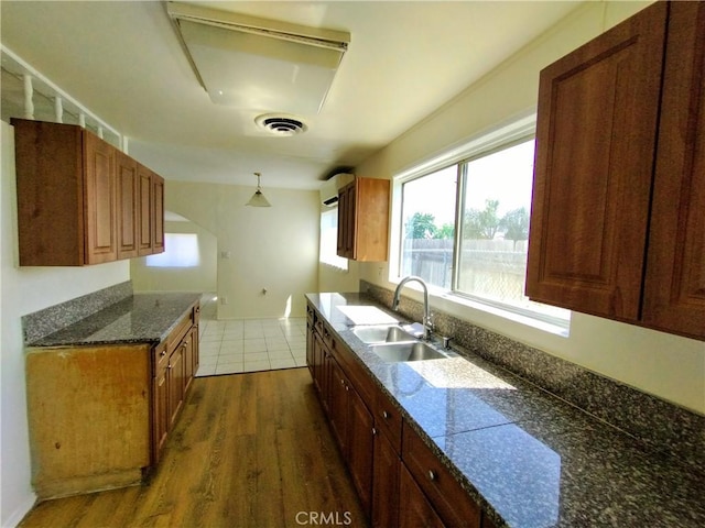 13410 Berg St, Sylmar, CA 91342 - kitchen with dark wood-style flooring, brown cabinets, and hanging light fixtures