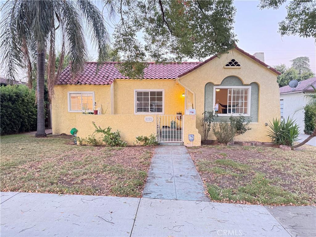2783 N Arrowhead Ave, San Bernardino, CA 92405 - mediterranean / spanish-style house featuring stucco siding, a fenced front yard, a tiled roof, and a gate
