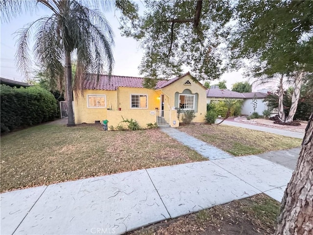2783 N Arrowhead Ave, San Bernardino, CA 92405 - mediterranean / spanish-style house with stucco siding, a gate, and a tile roof