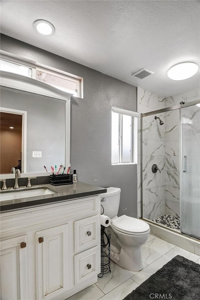 13203 Gyna Ln, La Puente, CA 91746 - bathroom with marble look tiles, a textured ceiling, a marble finish shower, vanity, and a textured wall