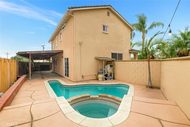 13203 Gyna Ln, La Puente, CA 91746 - back of house with a pool with connected hot tub, a patio, stucco siding, and a fenced backyard