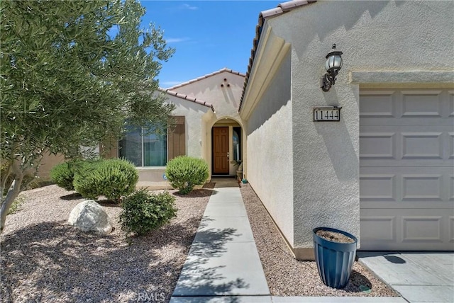 11444 River Run St, Apple Valley, CA 92308 - entrance to property with stucco siding, a tiled roof, and an attached garage