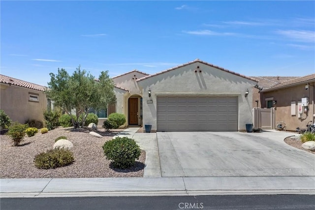 11444 River Run St, Apple Valley, CA 92308 - mediterranean / spanish house with a garage, driveway, stucco siding, and a tiled roof